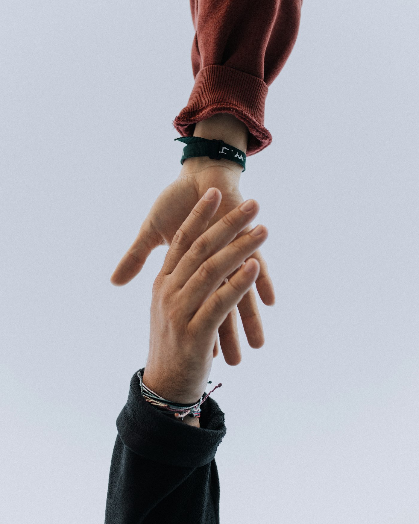 Adult hand reaching to help a child